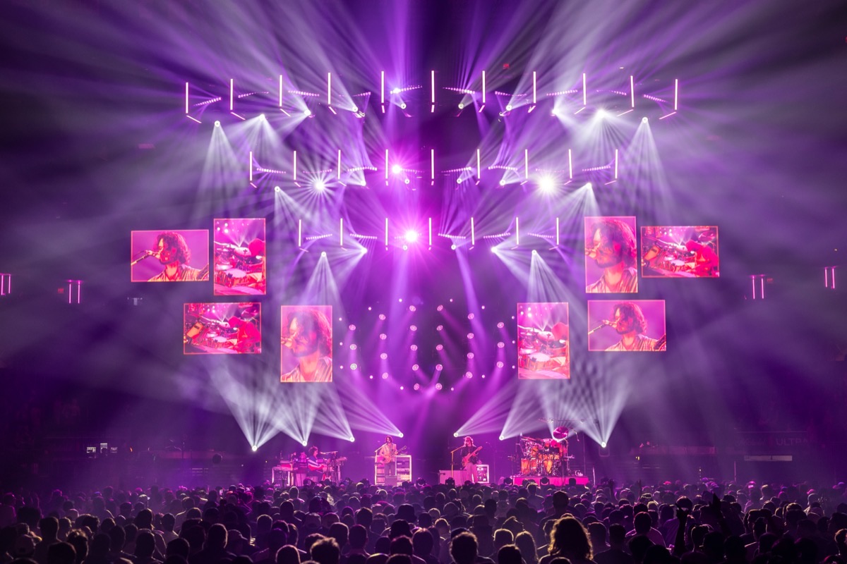 Goose at Madison Square Garden bathed in magenta light with band close-ups on the LED panels